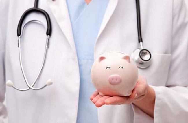 Doctor holding a piggy bank