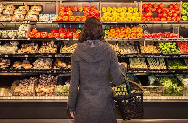 Woman standing in front of grocery aisle