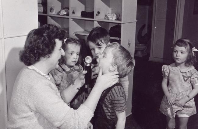 Old image of teacher with students (1940's)