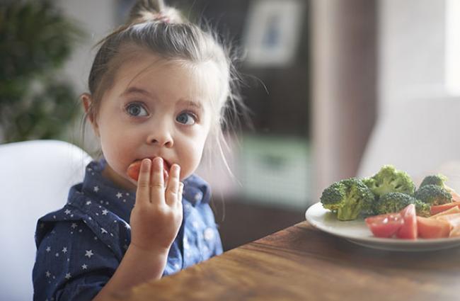 Child eating fruits and vegetables