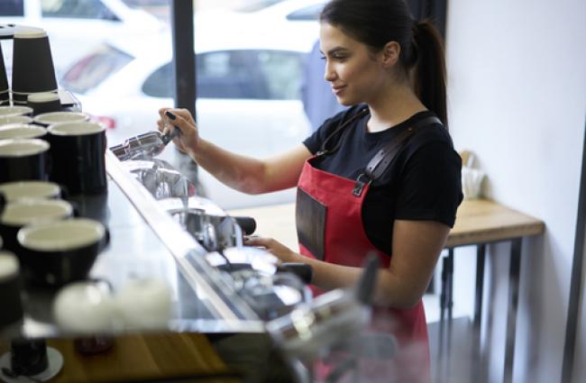 Barista at work making an espresso coffee