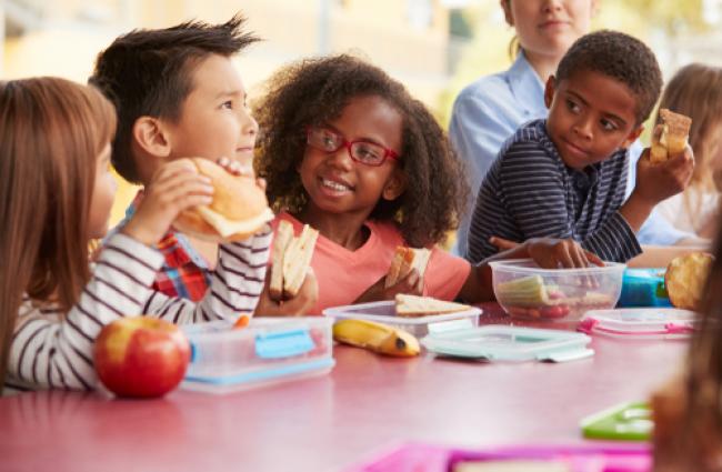 Children at a table eating lunch