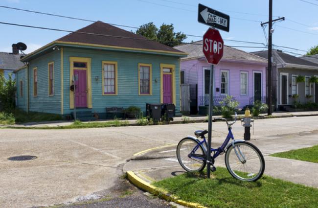 Bicycle leaning on stop sign at street corner