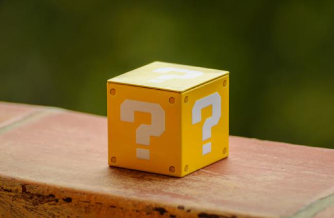Image of a yellow cube with a question mark on each side.