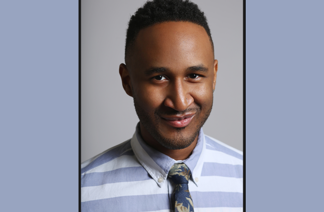 Terrell Winder, a smiling Black man with a blue and white striped button down shirt and a dark floral patterned tie