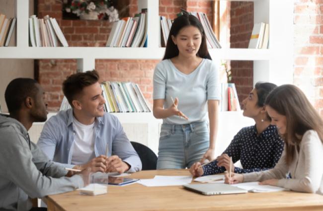 Students from a diverse background chatting around a table