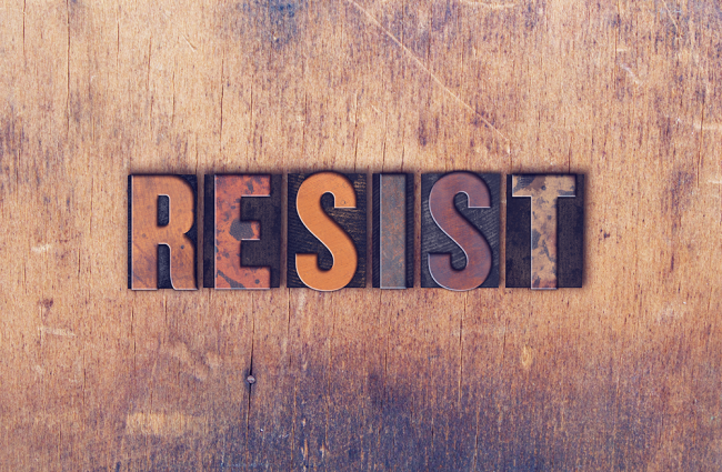 RESIST written using stamps