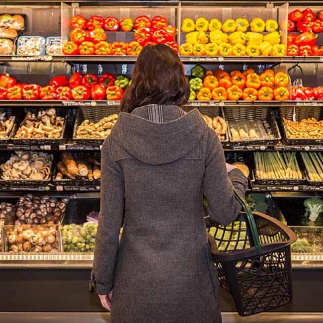 Woman standing in front of grocery aisle