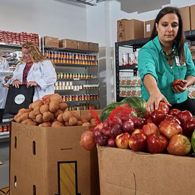 Women shopping produce at food pantry