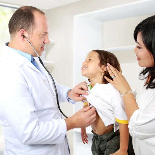 A doctor examining a child