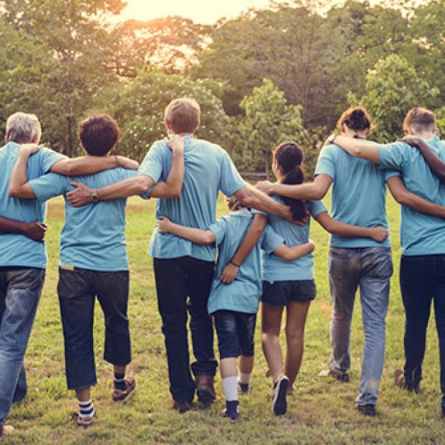 People embracing each other with back to camera