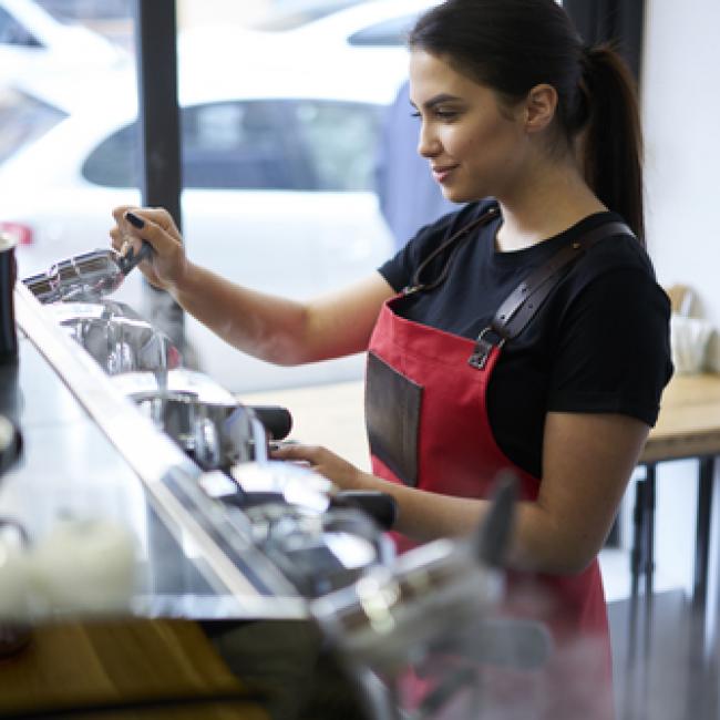 Barista at work making an espresso coffee