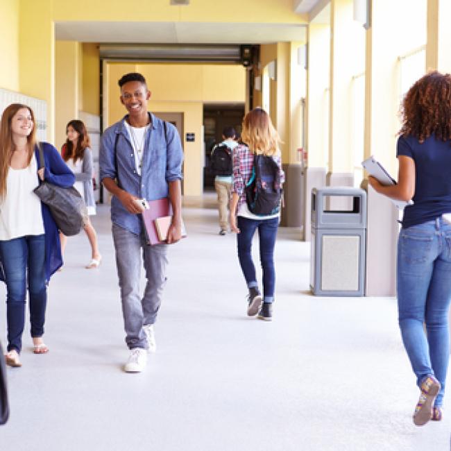 young teens walking down high school corridor