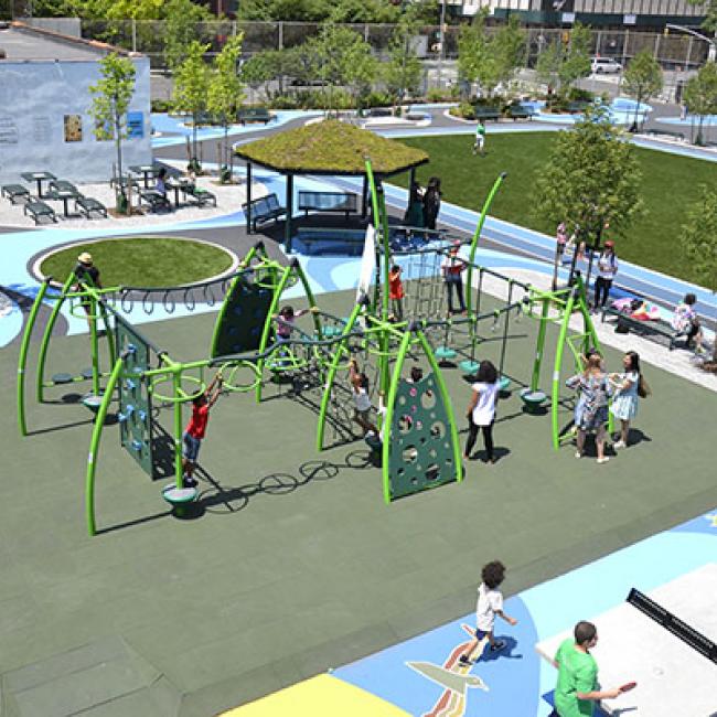 Image of children playing on playground equipment.