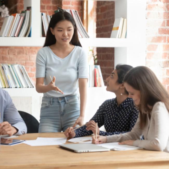 Students from a diverse background chatting around a table