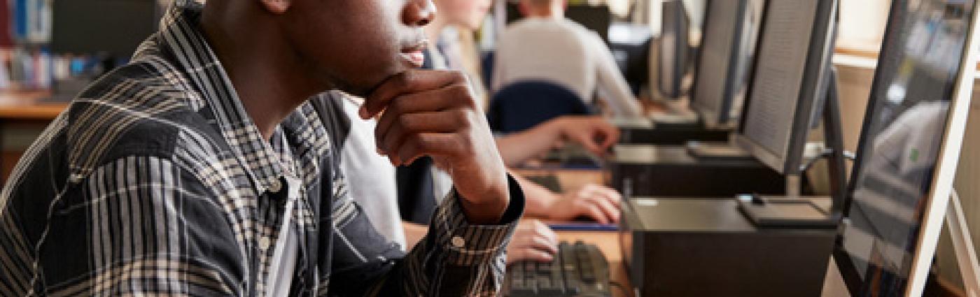 Teen looking at a computer