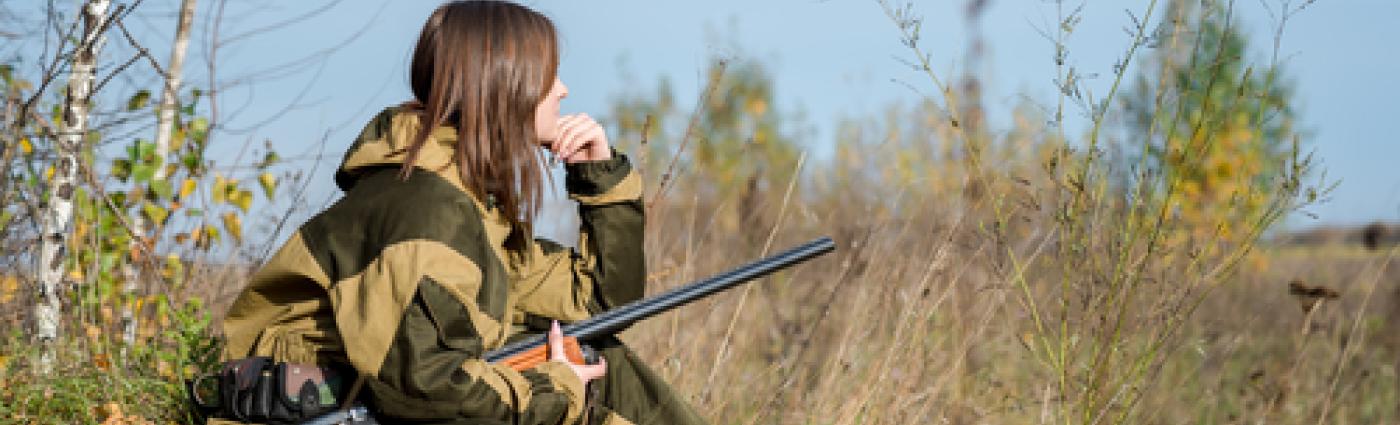 Women with firearm hunting for wild game