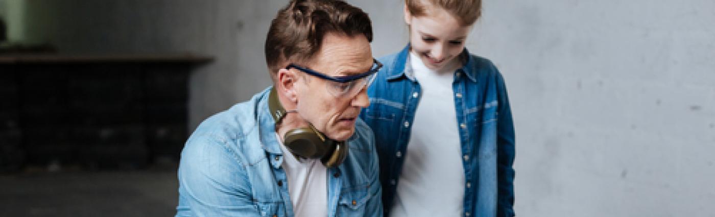 Image of man and child looking at a target.