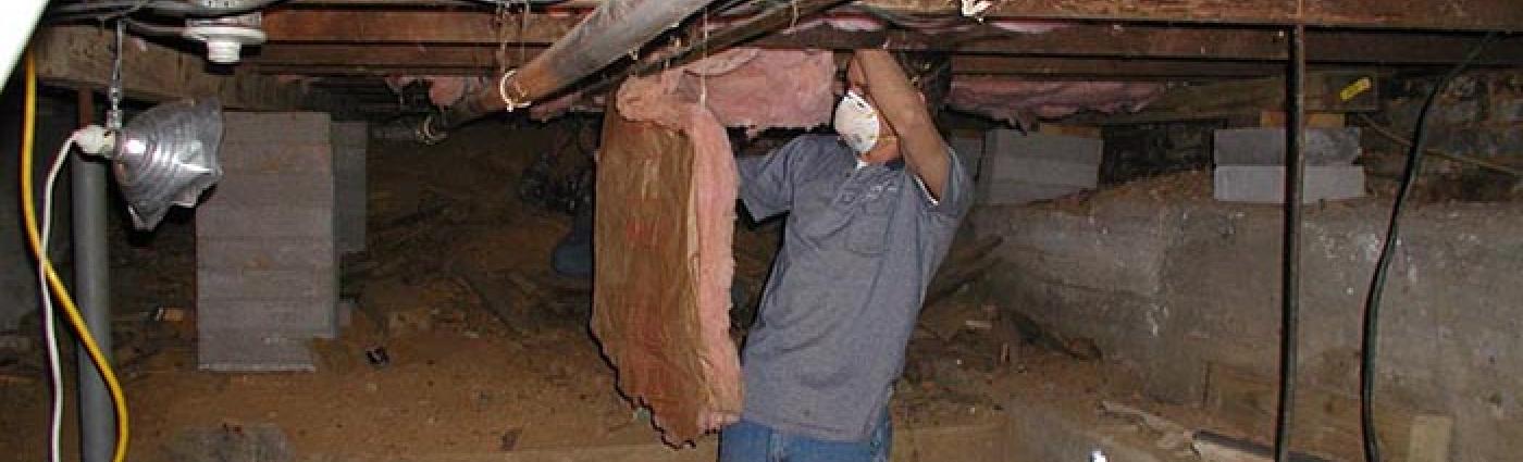 Image of a man working to weatherize a home.