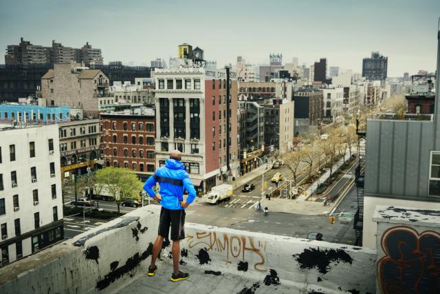 man standing over a city area