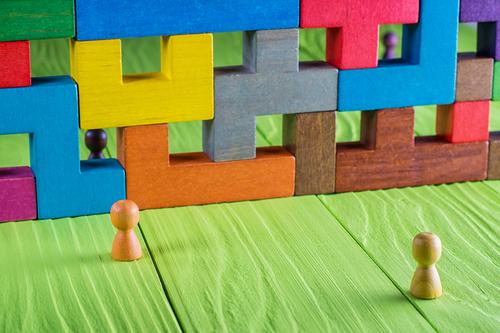 Colorful building blocks formed into a wall, representing a challenge