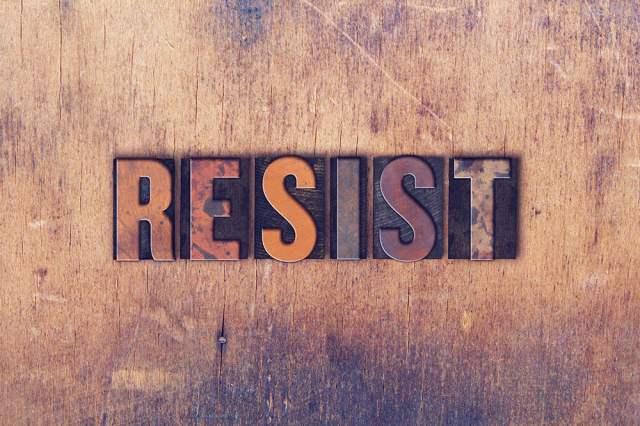 RESIST written using stamps